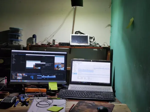 Documentation and software work beside the electronics bench.