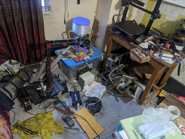 The feeder, printer and prototypes sharing the room-lab.
