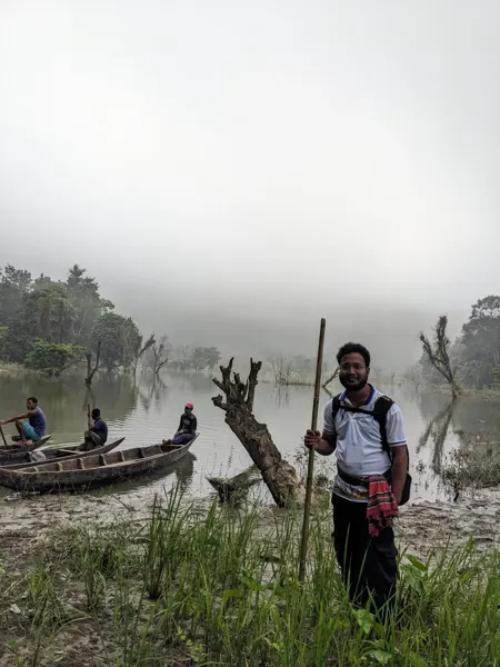 A misty waterside moment with boats in the background.