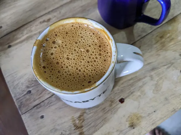 A cup of coffee beside the keyboard.