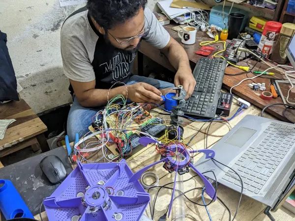 Feeder assembly and electronics work at the bench.