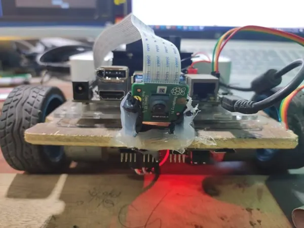 Camera-equipped mobile robot seen from the front.