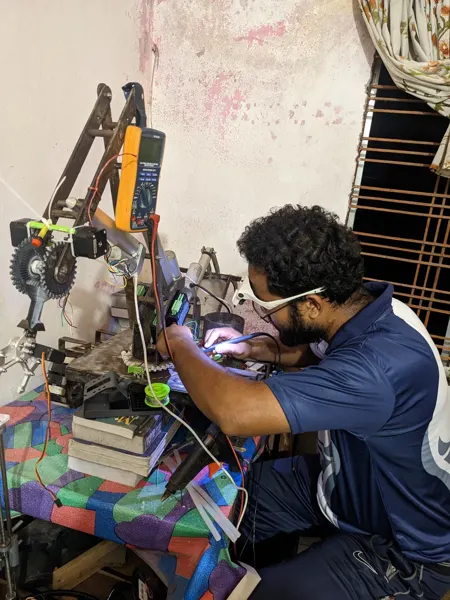 Hands-on integration work on an earlier robot prototype.